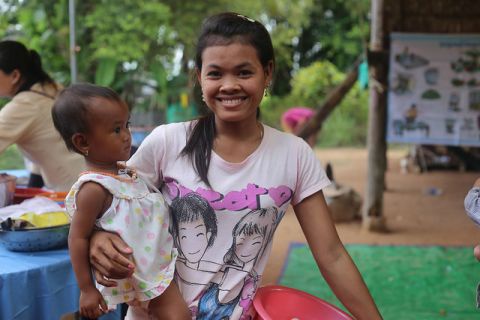 A mother with her child waiting for a nutrition course in Cambodia