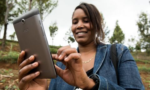 Woman uses mobile device to collect data