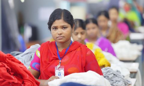 A garment worker is seen during her shift on a production line of a clothing plant in Bangladesh