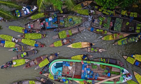 Farmers and traders in boats.