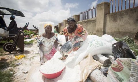 Women sell cassava flour in an Abuja, Nigeria, market
