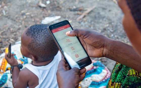 mother with cell phone and child