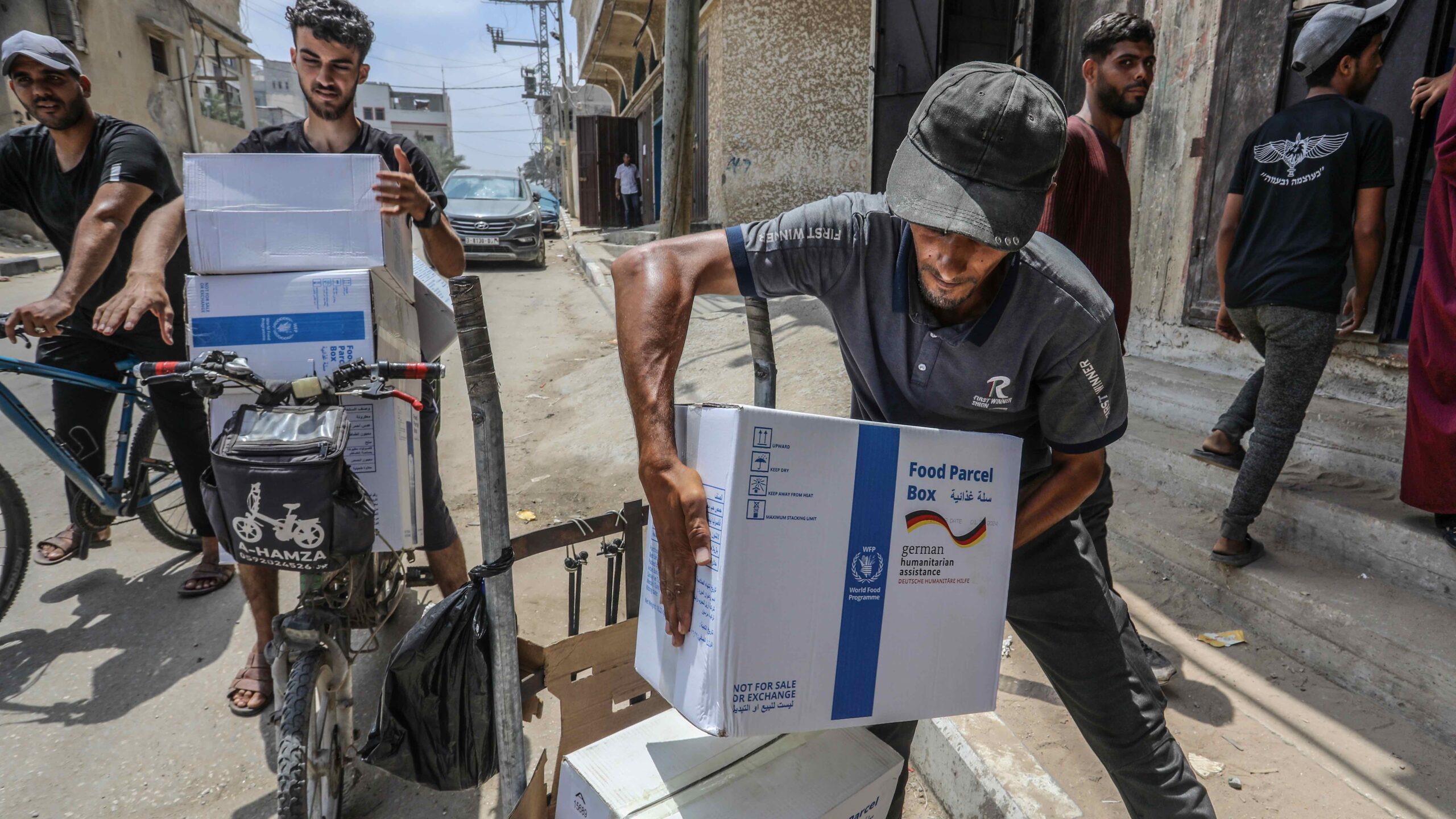 Men load boxes of food aid onto carts