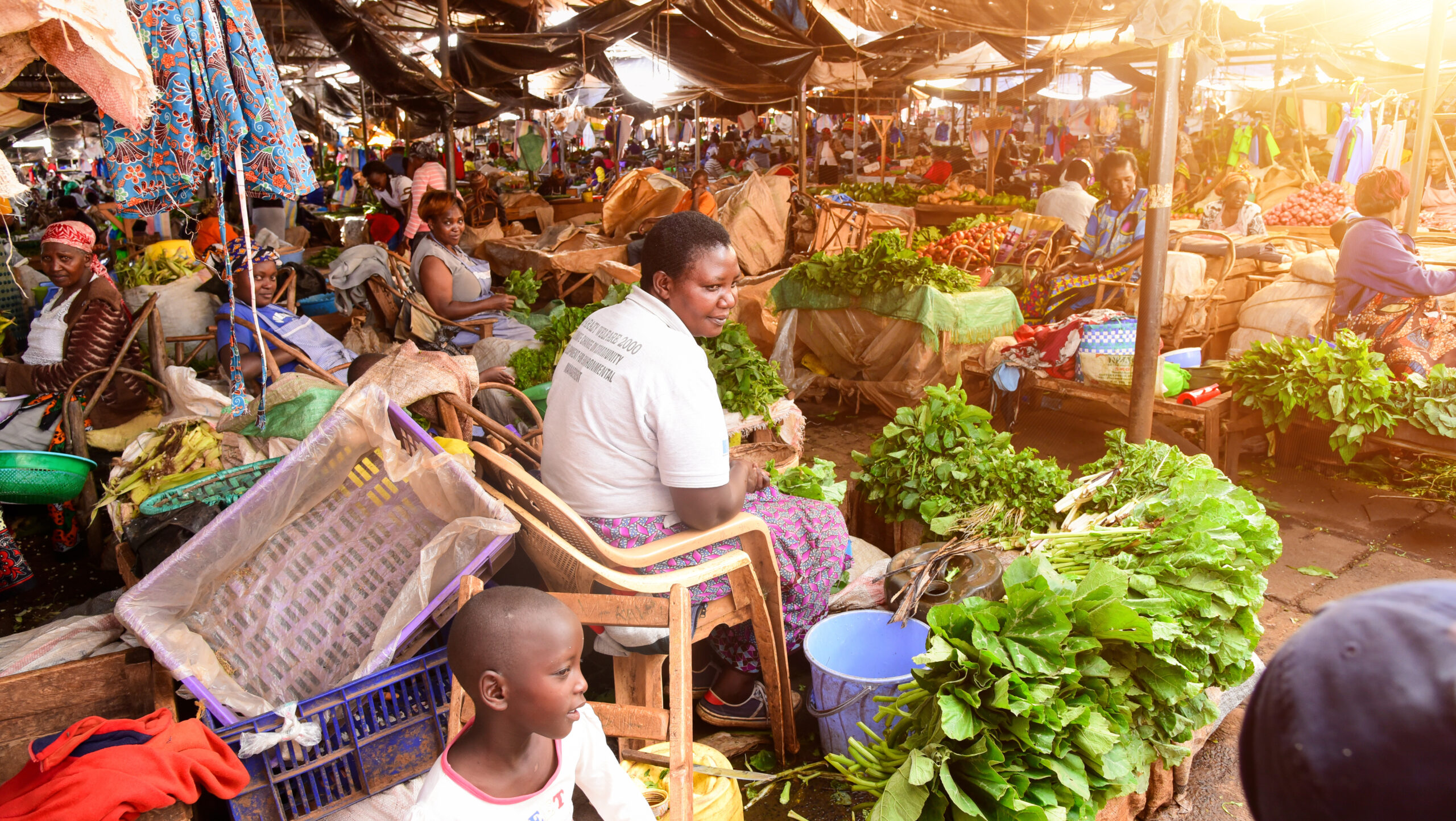 Vendors sitting amid piles of produce.