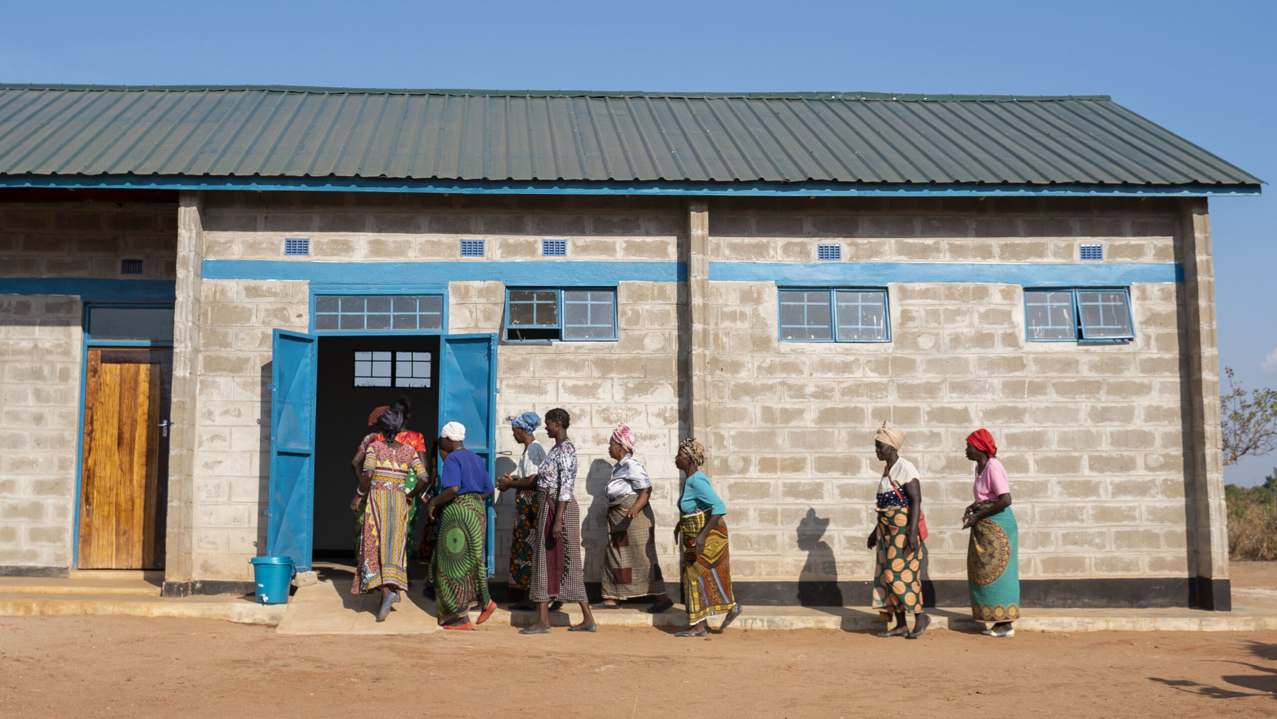 Women file into a doorway in a building